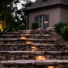 stone steps lit up with candles in front of a house