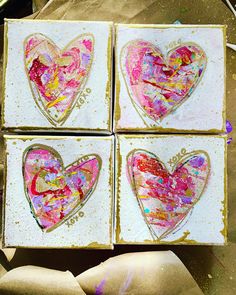 four heart shaped boxes sitting on top of a table