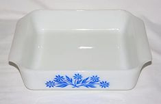 a white and blue dish with flowers on it