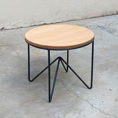 a wooden table sitting on top of a cement floor