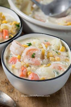 two bowls filled with shrimp and corn soup