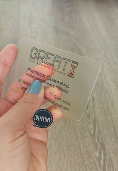 a person holding up a business card with the word great written in black on it