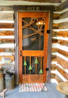 a wooden door sitting inside of a log cabin