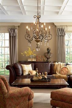 a living room filled with furniture and a chandelier