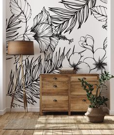 the wallpaper in this room is painted with black and white florals, which are on