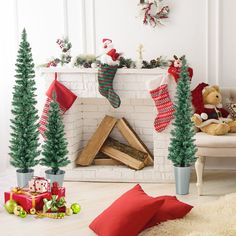 a fireplace with stockings and christmas trees in front of it