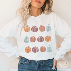 Oh my gourd! Enjoy our super cute and cozy fall pumpkins sweater. Soft and durable! PRODUCT INFORMATION 💡 ✅50% cotton, 50% polyester ✅Ribbed knit collar with seam ✅Without side seams ✅Loose fit ✅Sewn-in label ✅EASY MEASURING TIP: Take your favorite sweatshirt or tee, lay it on a flat surface and measure the width (armpit to armpit) and length (top to bottom), then compare with our size chart. Order up a size or two for baggier fit. CARE INSTRUCTIONS 🤍Machine wash cold 🤍Tumble dry ONLY low heat 🤍DO NOT iron 🤍DO NOT dryclean. HOW TO ORDER MULTIPLE SWEATSHIRTS 1. Select your size and color in the drop down menu & add to cart. 2. Go back and repeat for each shirt. SHIPPING & PROCESSING TIME 📦 - Please allow 3-5 business days for your order to be processed and made - Standard shipping tak Fall Aesthetic Pumpkin, Boho Pumpkin, Aesthetic Pumpkin, Oh My Gourd, Floral Pumpkin, Patch Shirt, Patches Shirt, Fall Sweater, Pumpkin Fall