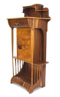 an antique wooden grandfather clock with carved wood panels and sides, in the manner of art nouveauism