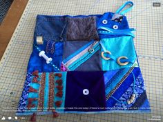 a patchwork bag with scissors and other items on it