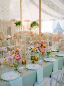 the table is set with flowers and place settings