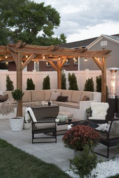 an outdoor living area with couches and chairs