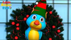 a blue bird with a green and red hat next to a christmas tree