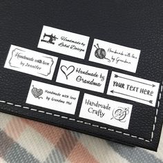 the labels are attached to the black leather case on the plaid fabric material, which has been stitched together with white stitching