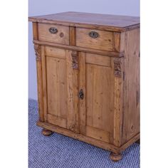 an old wooden cabinet with two doors on one side and three drawers on the other