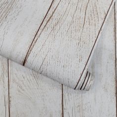 white wood textured wallpaper with brown lines on the bottom and bottom half of it