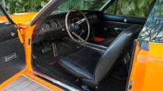 the interior of an orange and black car