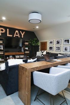 a living room filled with furniture and a flat screen tv sitting on top of a wooden table