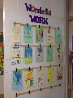 a bulletin board with post - it notes and magnets attached to the wall in a classroom