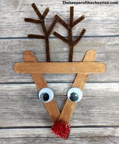 a reindeer made out of popsicle sticks with eyes