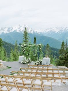 an outdoor ceremony setup with mountains in the background