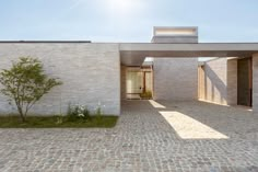 an empty courtyard with brick walls and trees