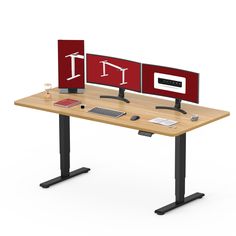 two computer screens sitting on top of a wooden desk next to each other with black legs