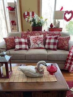 a living room filled with lots of furniture and pillows on top of a wooden table