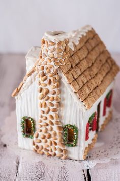 a gingerbread house is decorated with icing