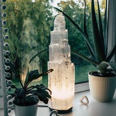 The Selenite Crystal Lamp is an exquisite and unique decoration piece that will bring a touch of elegance to any room. THese lamps measure between 8.25" up to 12" in height. This gorgeous lamp is made from natural selenite crystals, which are hand-crafted into a tower skyscraper shape. The light that illuminates through the shape of this lamp adds a calming glow to any room, making it an ideal choice for bedrooms, living rooms, dining rooms and more. Selenite, also known as Satin Spar, is a powe Salt Lamp Bedroom Aesthetic, Large Crystals Decor, Crystal House Decor, Crystal Wall Decor, Crystals Aesthetic Bedroom, Selenite Decor, Bedroom Lights Ideas, Crystal Lamps Bedroom, Crystal Bedroom Decor