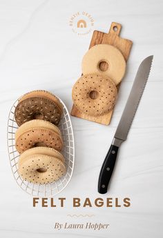 there are bagels and a knife on the table next to it is a cutting board that says felt bagels