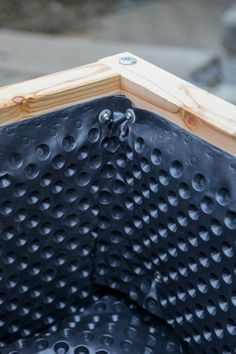 a close up view of the corner of a piece of wood with holes in it