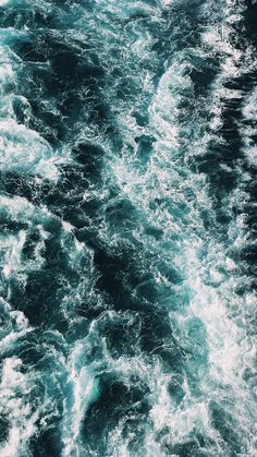 the water is very choppy and blue in this shot from a boat on it's side