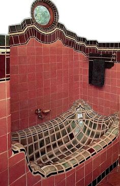 a bath room with a sink and a mirror on the wall next to tiled walls