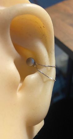 an ear is shown with a wire attached to it