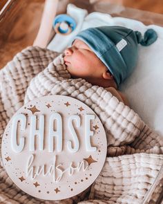 a baby sleeping in a crib with the name chase hudson on it