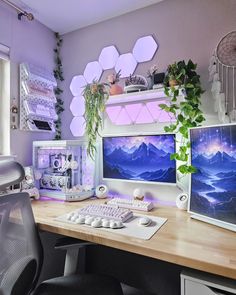 two computer monitors sitting on top of a wooden desk