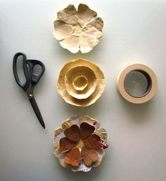 paper plates, scissors and tape are arranged on a white surface with other crafting supplies