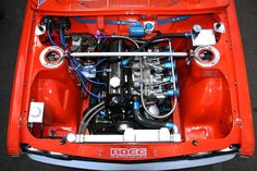 the engine compartment of an orange race car