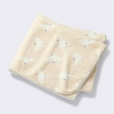 a white blanket with an animal print on it