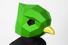 a green bird mask with yellow beak and black shirt