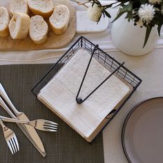 a table with silverware and bread on it