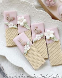 some pink and white treats are on a plate