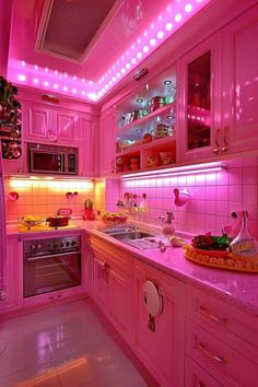 a kitchen with pink lighting and white counter tops on the walls, along with an oven and microwave