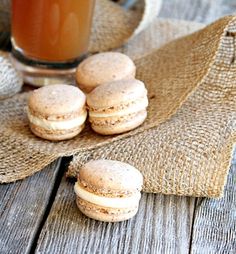 some cookies and a glass of tea on a table with burlap cloths