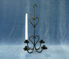 an iron candelabra with two candles on it