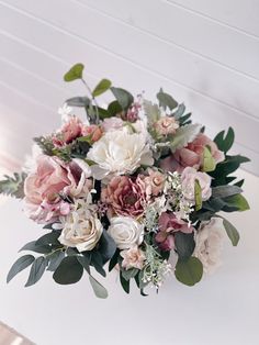 a bouquet of flowers sitting on top of a table