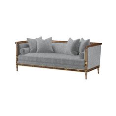 a gray couch with pillows on it and some gold trim around the armrests