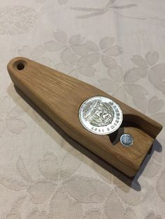 a wooden object with a metal button on it