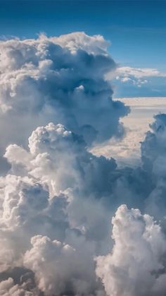 the view from an airplane looking down at clouds