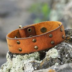 Armenian artisan Mikayel Torosyan captures bravery and elegance in a sturdy design for the everyday. This leather wristband bracelet features a gallant honey hue that enhances the brass accents around the structure. In addition, a buckle and a button closure allow you to adjust the length for a fitted look.